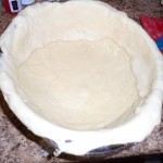 place rolled out dough in bottom of pie pan