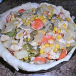 fill the pie pan with the chicken and vegetable mixture